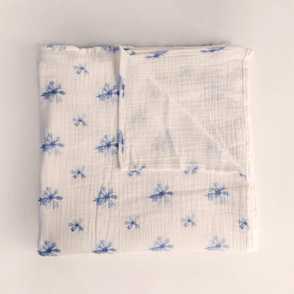 Cornflower muslin swaddle folded flat, blue cornflower heads on white