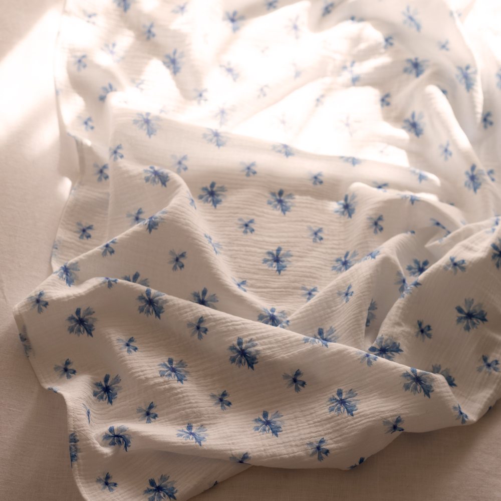 Fig, Snowberry and Cornflower swaddles folded in a stack